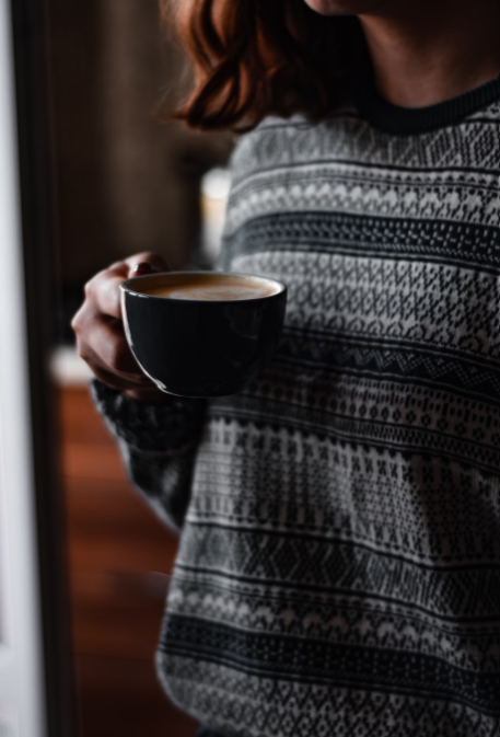 A woman drinking Lion’s Mane coffee.