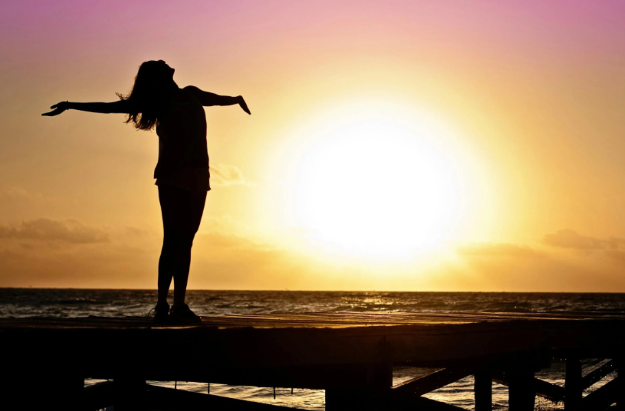 A healthy woman feeling revitalised after taking Turkey Tail for cancer support.