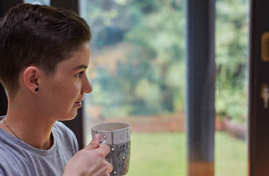 A person having lion’s mane mushroom coffee. 