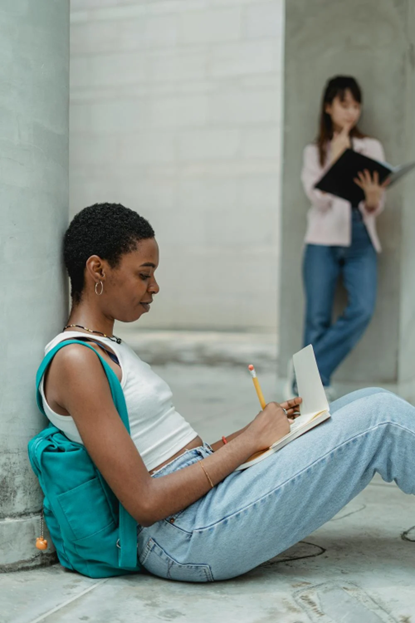 A woman works while sitting outdoors.